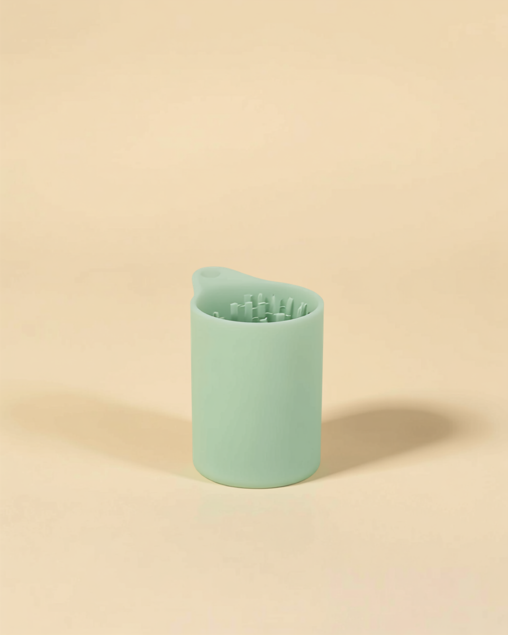 Muddy Paw Cleaner Cup - mint green silicone paw cleaner on cream background