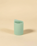 Muddy Paw Cleaner Cup - mint green silicone paw cleaner on cream background