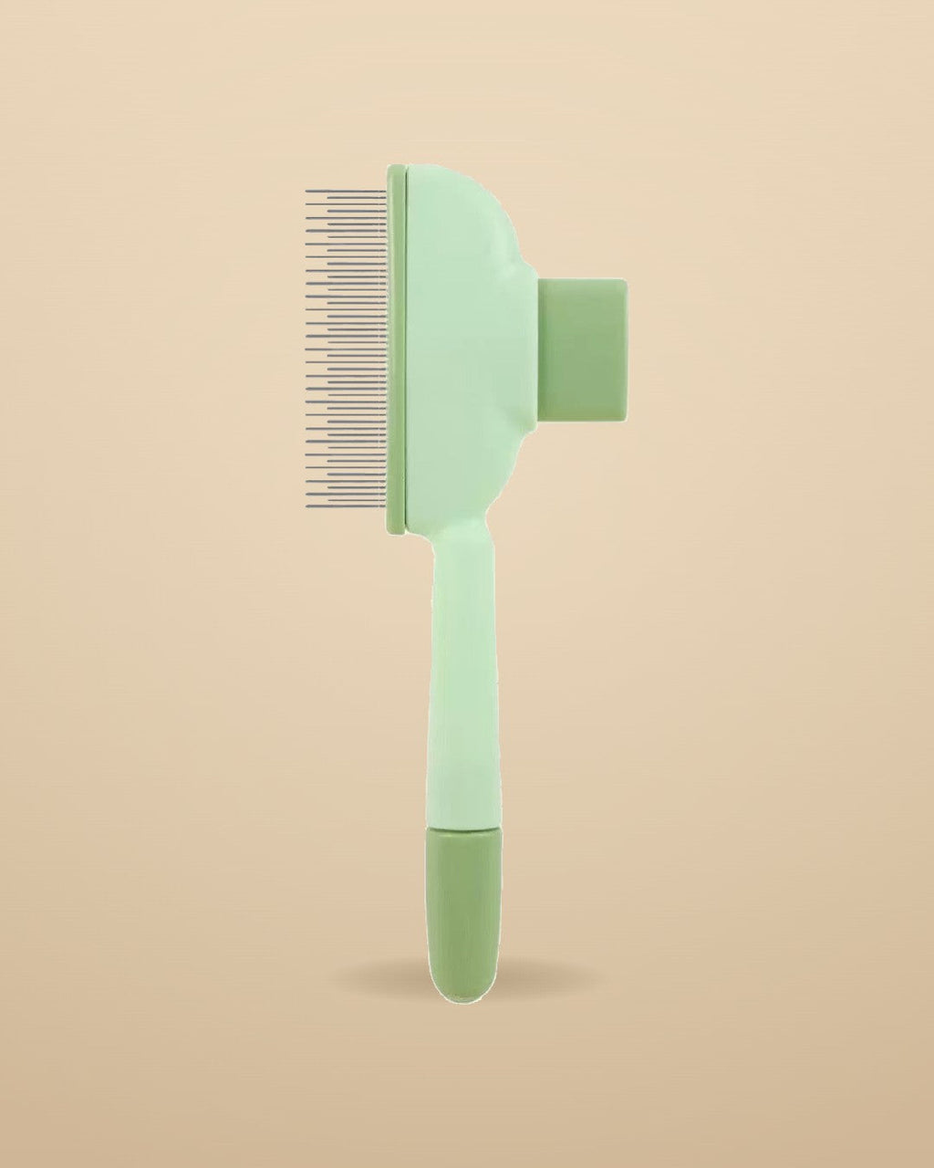 Pet Deshedding Brush in sage green on warm sand background