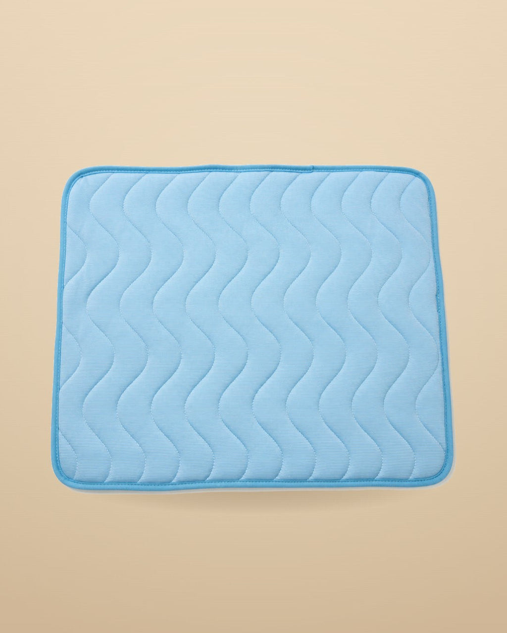 Pet Ice Silk Cooling Mat in blue on warm sand background